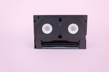 VHS video tape cassette on pink background