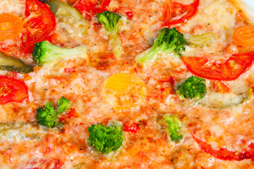 pizza with broccoli, tomatoes and vegetables closeup