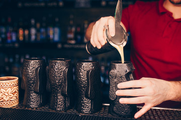 Bartender pouring using strainer White Sweet juicy Cocktail drink on a bar counter . Bartender view . Trendy stylish edit . Copy paste for design people and luxury concept service barman in nightclub