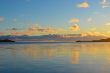 Fototapeta premium Winter landscape with lake and sunset clouds