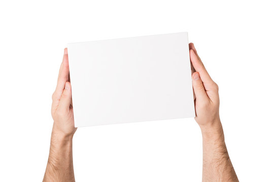 White rectangular box in male hands. Top view. Isolate