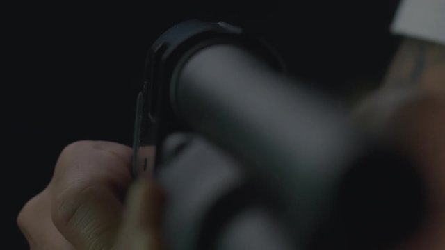 A shotgun shell is ejected from a shotgun. Close up shot, shallow depth of field