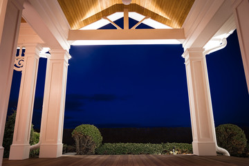 Night view of PVC millwork, pillars, and woodwork on home residence.