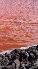 24 November 2018 La Palma Canary Islands, Salinas Marinas de Fuencaliente, Salts Flats and Mine showing multi coloured salt water fields aganst blue sky and waves