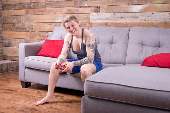 blond woman playing video games expression joy and happiness