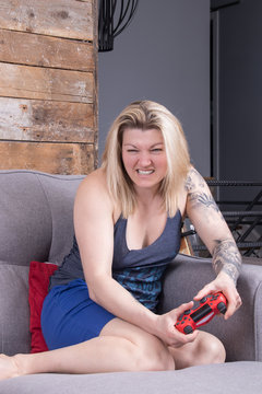 blond woman playing video games expression concentration
