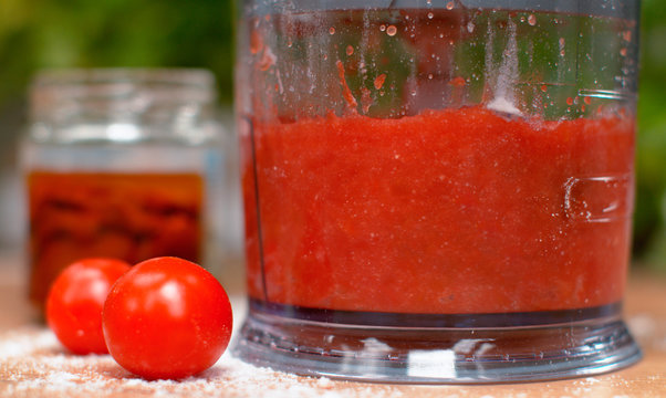 MACRO: Delicious Marinara Sauce Is Being Mixed With Rock Salt Inside A Blender.