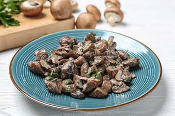 Plate of tasty fried mushrooms with sauce on table