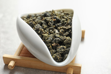 Chahe of Tie Guan Yin oolong tea leaves on light background, closeup
