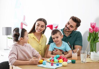 Obraz na płótnie Canvas Happy family with Easter eggs at home. Festive tradition