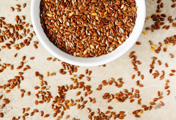 Flax seeds on bowl, top view.