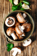Fresh mushrooms on wooden background, top view