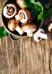 Fresh mushrooms on wooden background, top view