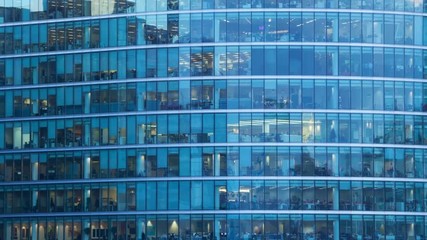 Day to night Timelapse of the exterior of an office block at night revealing the daily activity of office workers night themes of routines working late deadlines