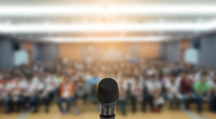 Microphone over the Abstract blurred photo of conference hall or seminar room with attendee background,Small Business training concept,Public speaking - obrazy, fototapety, plakaty