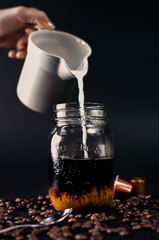 pouring milk in coffee