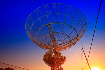 The silhouette of a radio telescope observatory