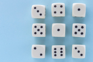 White gaming dices on light blue background. victory chance and lucky. Flat lay style, place for text. Top view and Close-up cube. Concept business, gamble and game. Spectacular background pastel.