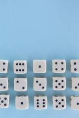 White gaming dices on light blue background. victory chance and lucky. Flat lay style, place for text. Top view and Close-up cube. Concept business, gamble and game. Spectacular background pastel.