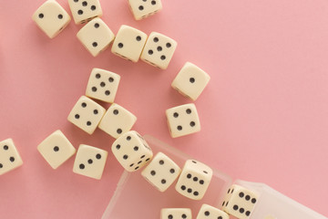 White gaming dices on pink background. victory chance and lucky. Flat lay style, place for text. Top view and Close-up cube. Concept business, gamble and game. Spectacular background pastel.