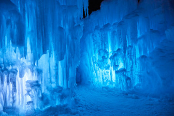 Wall of blue icicles on a subzero night after sunset on a lake in Minnesota USA