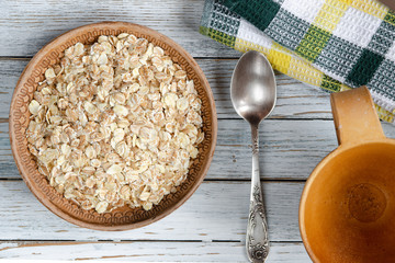 oatmeal in a clay plate on a wooden board