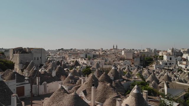 Drone footage over the distinct traditional stone Trulli houses and roofs of Alberobello in southern italy, Apulia, Puglia. Shot on the DJI Mavic Air.