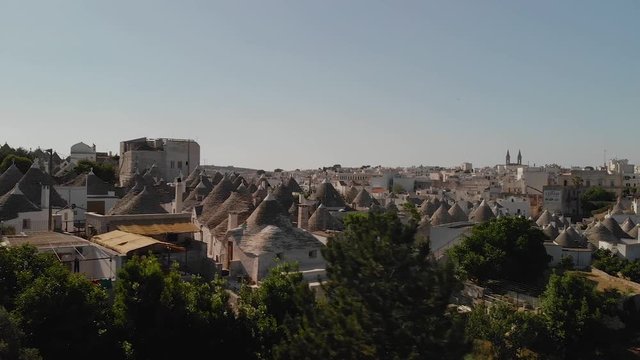Drone footage over the distinct traditional stone Trulli houses and roofs of Alberobello in southern italy, Apulia, Puglia. Shot on the DJI Mavic Air.