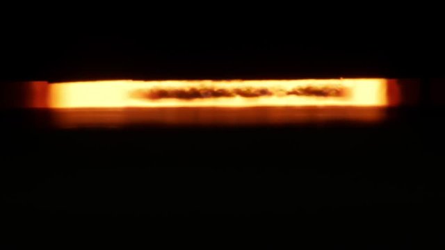 blurring splashes of fire inside industrial furnace in ceramic tile manufacturing in plant