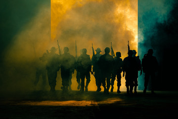 silhouette thai soldiers special forces team full uniform walking action through smoke and holding gun on hand