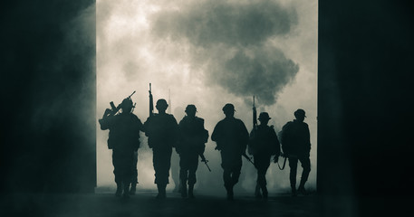 silhouette thai soldiers special forces team full uniform walking action through smoke and holding...