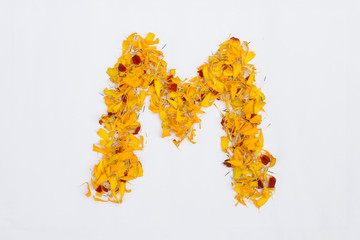 Spring Flower Letter concept of Marigold petal. Marigold petal alphabet isolated on white background. Letter M concept Logo.