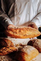 Professional baker showing different kinds of gluten free bread