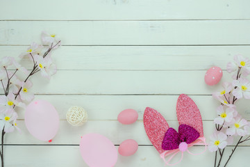 Table top view shot of decoration Happy Easter holiday background concept.Flat lay variety bunny eggs with pink flower and decor for festive season on modern rustic white plank wood.copy space design.