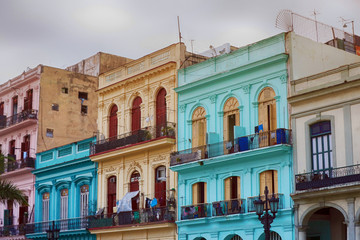 Old Spanish colonial living colorful houses across the road in the center of Havana, Cuba