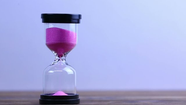 Hourglass. Running Sand in the Sandglass