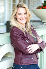 Portrait of a confident woman smiling outside.