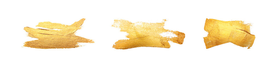 Set of isolated brush strokes with gold paint on a white background. Golden smear.