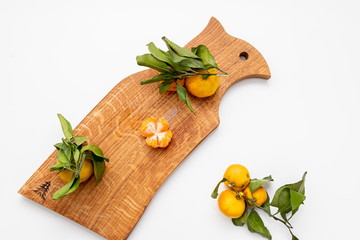 Peeled mandarin on the peel in the form of a flower on cutting board.Copy space.Nature fruit concept.Composition of Mandarins, tangerines. Vegetarian food farm food organic food vegan.