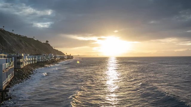 Time lapse of a sunrise breaking through the clouds over the ocean in California.
