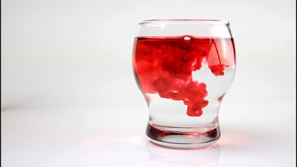 Red water droplet on transparent glass