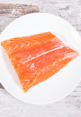 Fresh healthy salmon on plate, food containing omega 3 acids