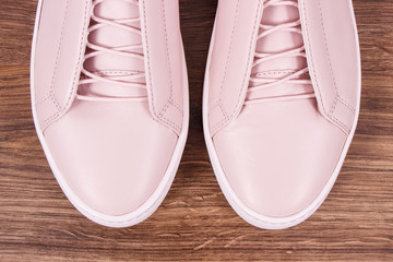 Womanly pink leather shoes on rustic board