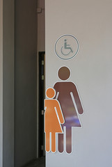 Toilet female signs on cement wall background.