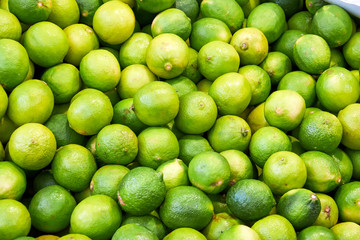 A pile of limes for sale at a market