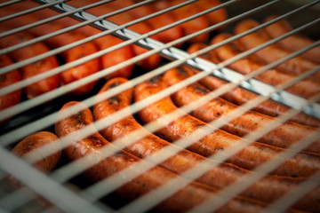 Sausages are grilled. Cooking sausages barbecue. Fast food. Lattice BBQ