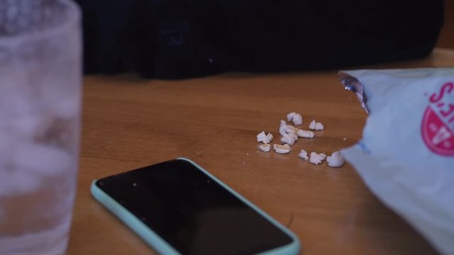 Woman grabbing and eating popcorn