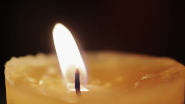 Macro shot of a candle dancing in the wind.