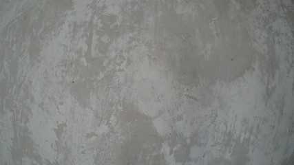  Gray concrete wall with scrapes of old wallpaper