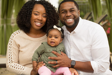 Happy African American family with their baby.